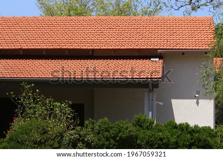 The roof of the house is made of red tiles. Architectural details of housing construction in Israel.