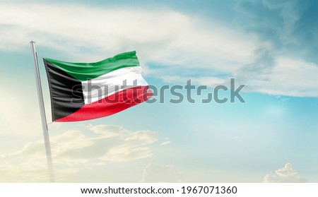 Kuwait national flag waving in beautiful sky. Royalty-Free Stock Photo #1967071360