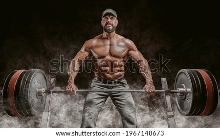 Muscular bearded man lifts a barbell. Bodybuilding, fitness, powerlifting concept. Mixed media Royalty-Free Stock Photo #1967148673