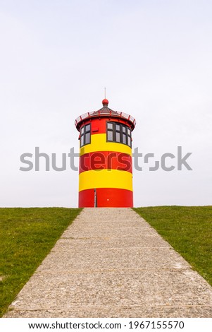 The Pilsumer lighthouse in Greetsiel, Krummhorn, Lower Saxony, Germany Royalty-Free Stock Photo #1967155570