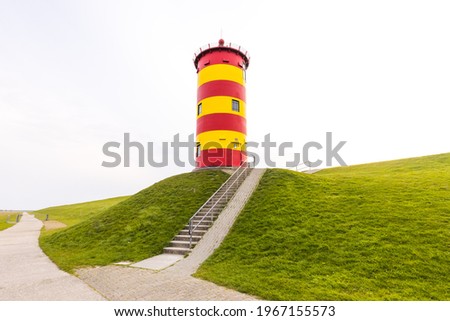 The Pilsumer lighthouse in Greetsiel, Krummhorn, Lower Saxony, Germany Royalty-Free Stock Photo #1967155573