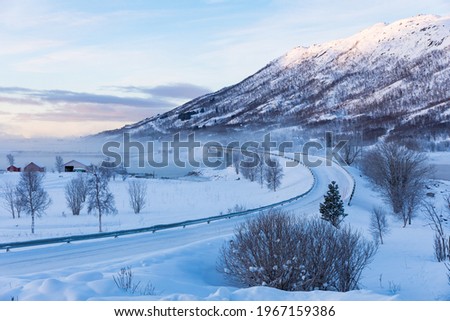 icy road in winter, Lofoten, Norway Royalty-Free Stock Photo #1967159386
