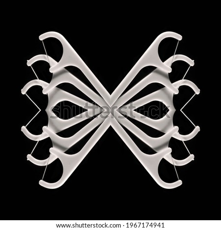 Abstract kaleidoscopic pattern of dental floss sticks isolated on black background