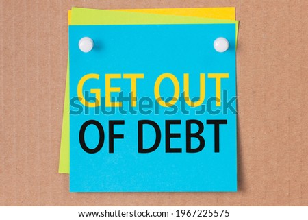 business phrase - get out of debt - written on blue square sticker and pinned on paperboard, concept Royalty-Free Stock Photo #1967225575