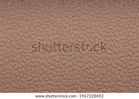 Embossed brown soft silicone background. Closeup