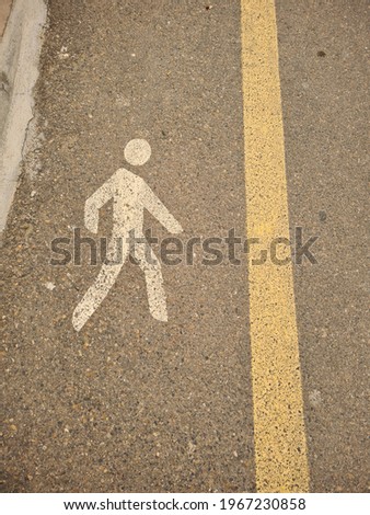 pedestrian zone painted on the road with a yellow line