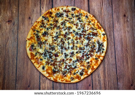 Hot pizza with ham, bechamel sauce, mushrooms, bacon and cheese.Concept poster for restaurants or pizzerias.