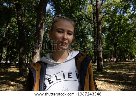girl with glasses in the park in sunny weather