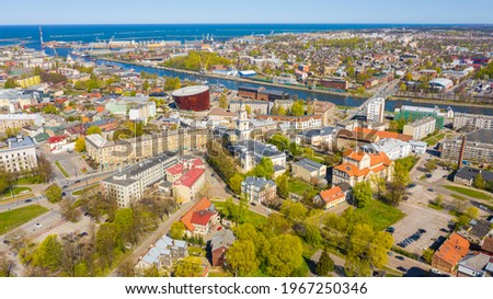 Liepaja,Latvia,Baltics.Beautiful panoramic aerial view photo from flying drone to Holy Trinity Cathedral,Concert hall Great Amber (Lielais dzintars) and city center, trade channel in spring. (Series) Royalty-Free Stock Photo #1967250346