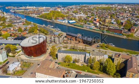 Liepaja,Latvia,Baltics.Beautiful panoramic aerial view photo from flying drone to Holy Trinity Cathedral,Concert hall Great Amber (Lielais dzintars) and city center, trade channel in spring. (Series) Royalty-Free Stock Photo #1967250352