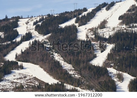 A landscape of the Norefjell Ski Resort covered in the snow under the sunlight in Norway