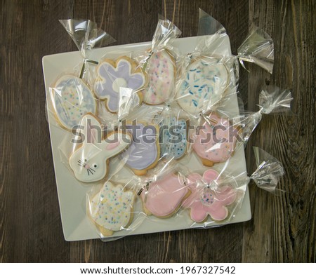 Top view of Easter sugar cookies with royal icing in clear goodie bags.
