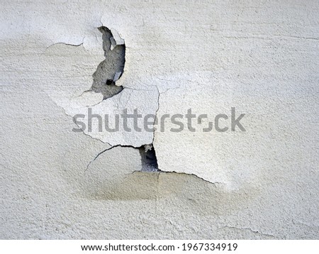 A closeup shot of cracked paint on the concrete wall