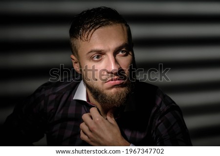 Portrait of confident young handsome businessman correcting collar of his shirt