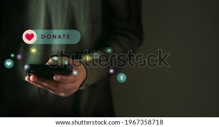 Online Donation, Volunteer and Charity Concept. Making Donate via Internet on Mobile Phone. Closeup shot Royalty-Free Stock Photo #1967358718