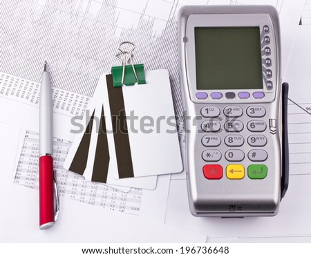 Business still-life of tables, payment terminal, credit Cards, paperclip, pen