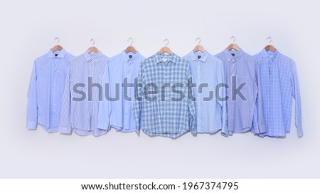 Set of striped,blue  long sleeved plaid, lshirts on hanging