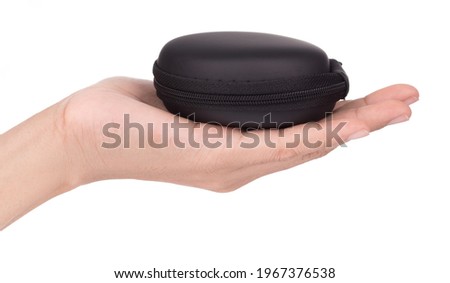 Hand holding headphone bag earbuds, case box, wallet coin bag  isolated on white background.