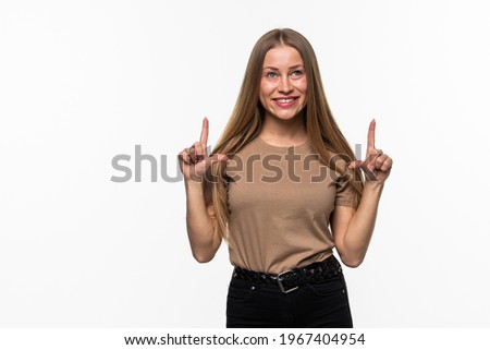 Happy woman pointing up with both hands isolated on a white background