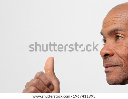 showing thumbs up hand gesture on whit background stock photo 
