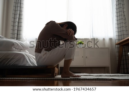 Close up young Asian woman feeling upset, sad, unhappy or disappoint crying lonely in her room. Woman health mental problem concept. Royalty-Free Stock Photo #1967434657