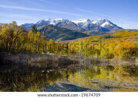 High mountain lake in the fall showing autumn colors reflected in the water Americana
