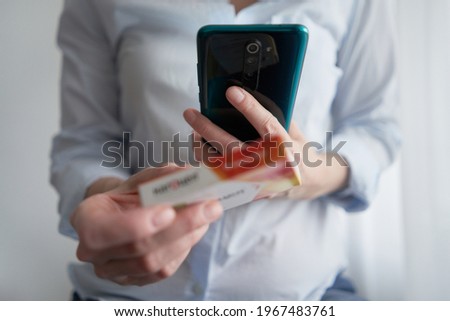 The girl woman uses a smartphone to buy medics online. Shopping at an online store.