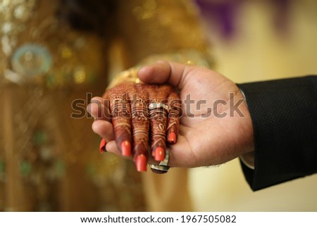 Pakistani indian bridal and groom holding hand and showing wedding rings  Royalty-Free Stock Photo #1967505082