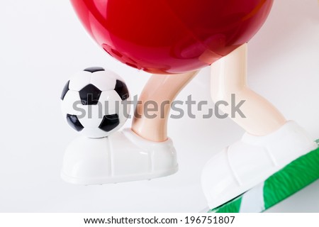 Soccer ball on the leg. Football game toy on a white background