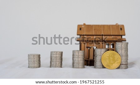 Bitcoin and coin pile, background with brown house design