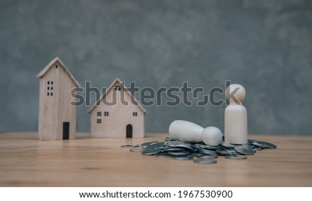 Wooden modern house model with cubic block and family with money on the table. Engineering real estate and contractor design concept. Use for texture investment banner and bank website.