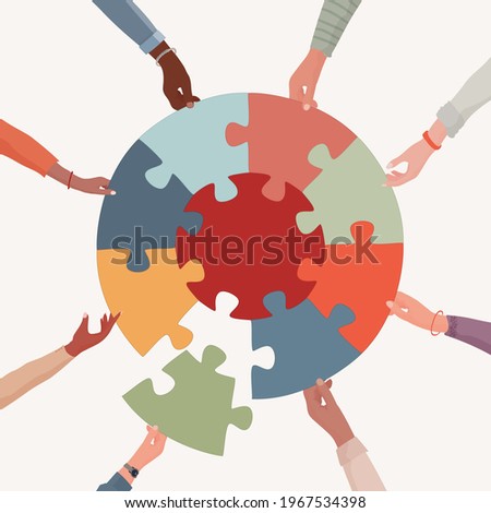 Missing link.Arms of hands of people or co-workers of diverse races holding jigsaw puzzle pieces that connect. Problem solving.Union and teamwork. Collaborating.Strategy.Match. Toy Royalty-Free Stock Photo #1967534398