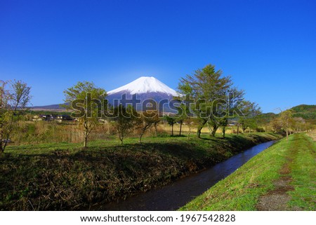 Mt. Fuji in the spring blue sky from the Shinnasho River in Oshino Village Japan Royalty-Free Stock Photo #1967542828
