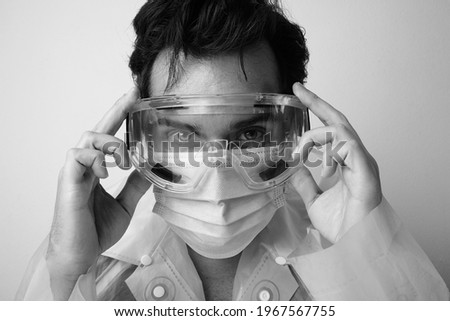 Portrait of doctor wears mask and protective glasses he has a lot of stress.