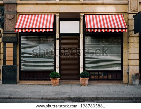 closed and locked clothier or dress outfitter, shop front, impact of the coronavirus pandemic 2021 in Germany.