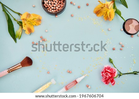 Summer background with make up accesories, flowers and powder. Beauty concept copy space. Feminine colorful concept. . High quality photo