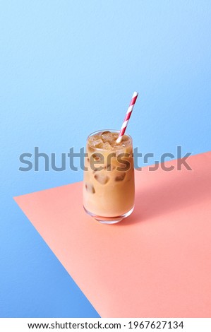 Iced Coffee with Milk in Tall Glasses on Pink Table and Blue Background. Isometric Vertical Orientation Royalty-Free Stock Photo #1967627134