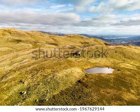 Aerial sunset view of the Lake District, famous for its glacial ribbon lakes and rugged mountains. Popular vacation destination in Cumbria, North West England. Tourist attractions in Great Britain.