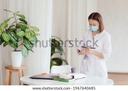 Stock Photo - Scientist is conducting experiments, tests with plants in petri dish at laboratory. Biotechnologist is injecting chemical substance to leaves with syringe. Biologist workplace. GMO conce