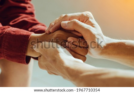 Couple are holding hands and pray together 