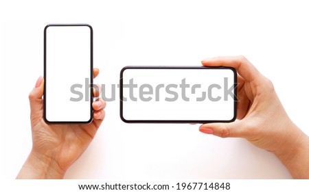 Mobile phone with empty white screen in hand in horizontal and vertical orientation, isolated on white background