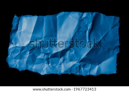 blue piece of paper on black isolated background
