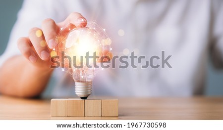 hand touching on light bulb with connection line. new idea concept with innovation and inspiration, innovative technology in science and communication concept. Royalty-Free Stock Photo #1967730598