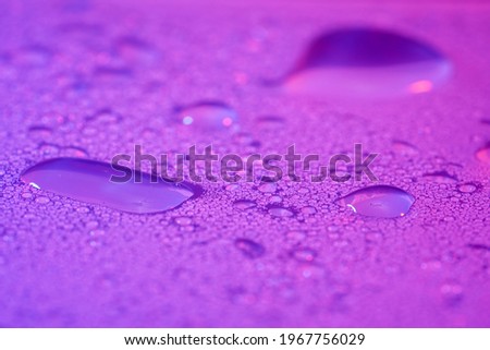 Rain with splashing water droplets photographed in spring in Germany                            