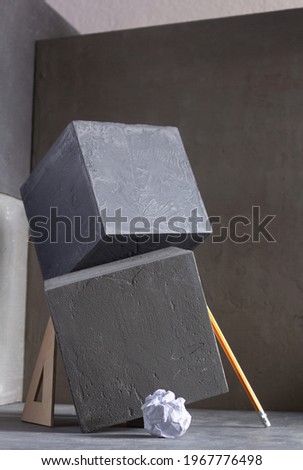 Concrete cube near wall background texture. Abstract art or construction concept of minimalism design