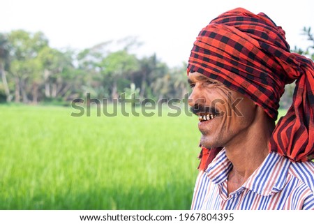 Portrait Of Smiling Man Or Farmer In Rice Field

