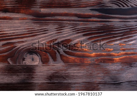 Old grungy burning wood surface texture. Rustic old reclaimed wood background