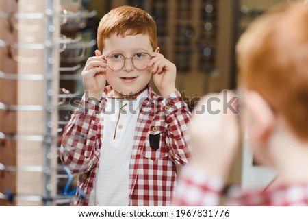 boy in glasses at optics store