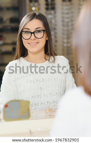 Girl Shopping for Glasses on Sale Season in Optic Store. Stylish customer buying many eyeglasses on discount