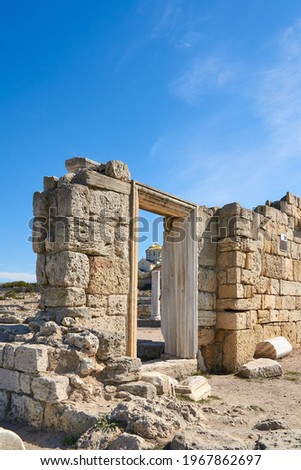 Ruins of an ancient Greek temple against the background of the Vladimir Cathedral in Chersonesos